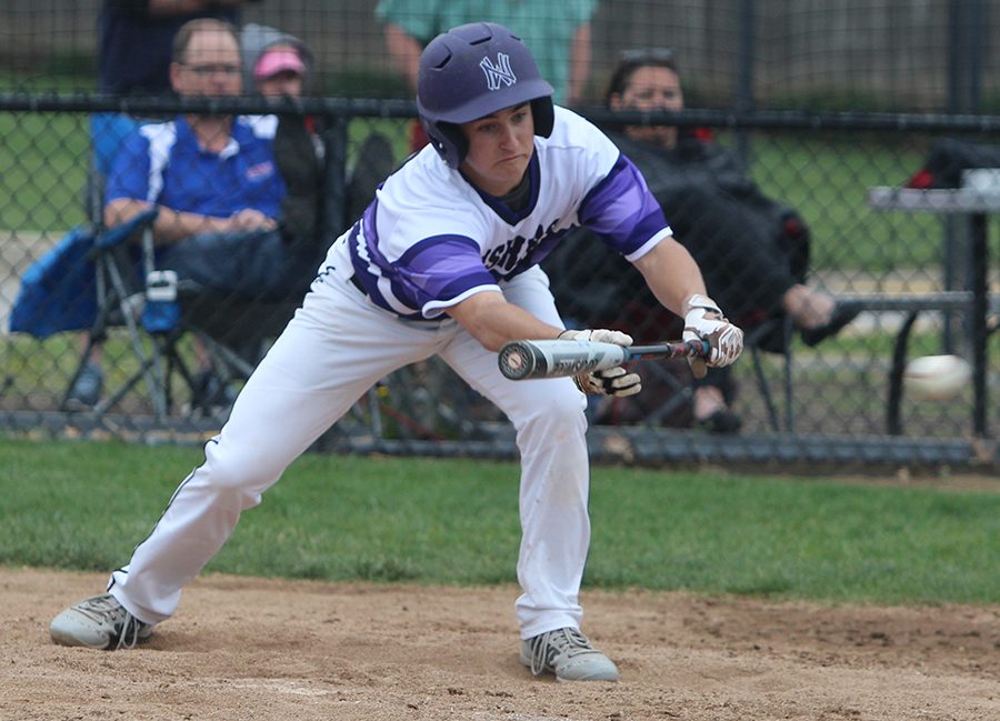 Junior Tyler McQuinn lays down a sacrifice bunt during the top of the fourth inning of the Huskies matchup with Bishop Miege May 1. The Huskies defeated the Stags, 4-3. 
