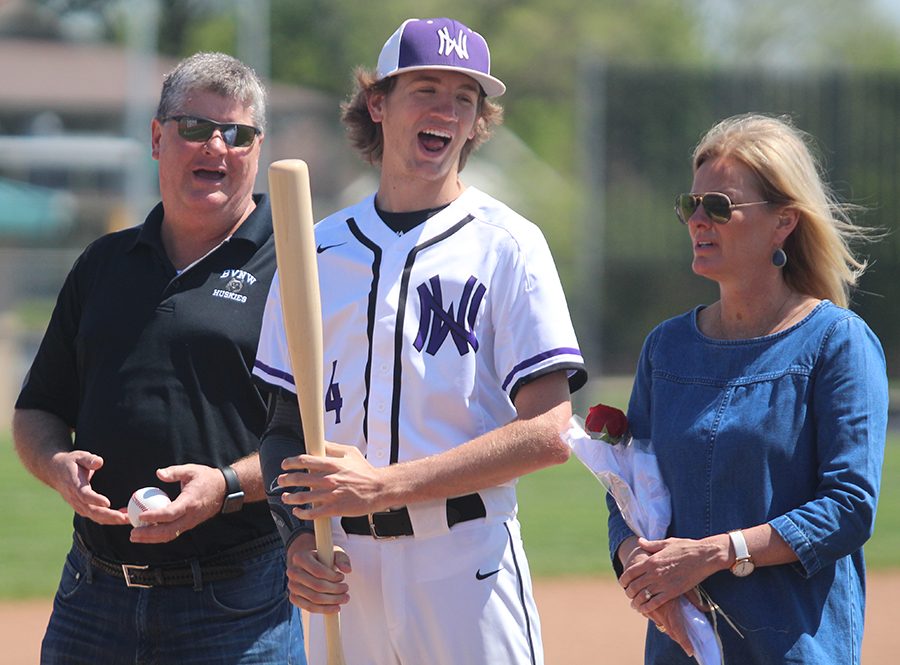 Senior pitcher Max Abromovich talks to his parents as he is honored prior to the game against Shawnee Mission South at the DAC May 5. The Huskies lost to the Raiders 3-4 in eight innings.