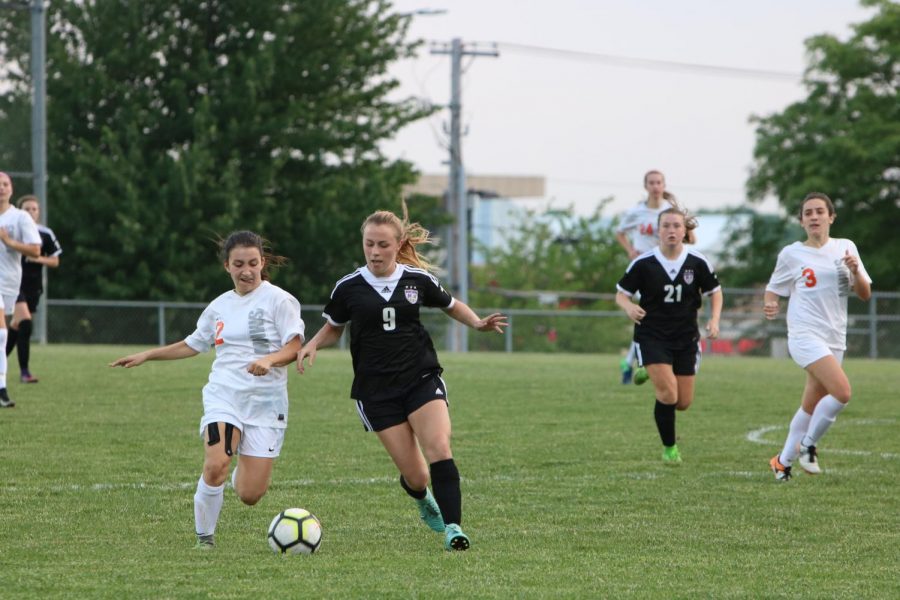 Sophomore Megan Crist goes for the ball against Shawnee Mission Northwest in the second round of regionals on Thursday, May 17. The Huskies were defeated by the Cougars, 1-2.