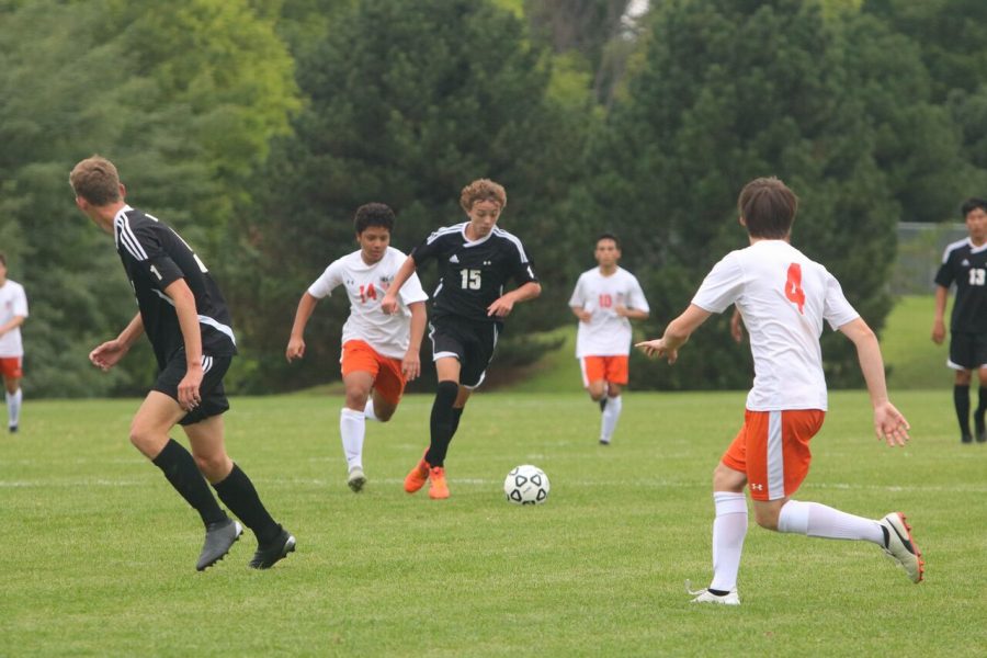 Sophomore Christian Colle dribbles up the field against Shawnee Mission Northwest on Aug. 29 at the Blue Valley West sub-varsity fields. BVNW defeated SMNW, 3-1.