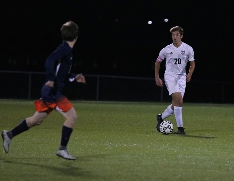 Senior Trevor Ellefson (20) surveys the field in the game against Olathe West on Oct. 23 at the ODAC. The Huskies were defeated by the Hawks, 5-1.