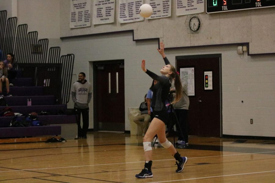 Sophomore Maddie Clark serves the ball in the game against Blue Valley North on Oct. 12.