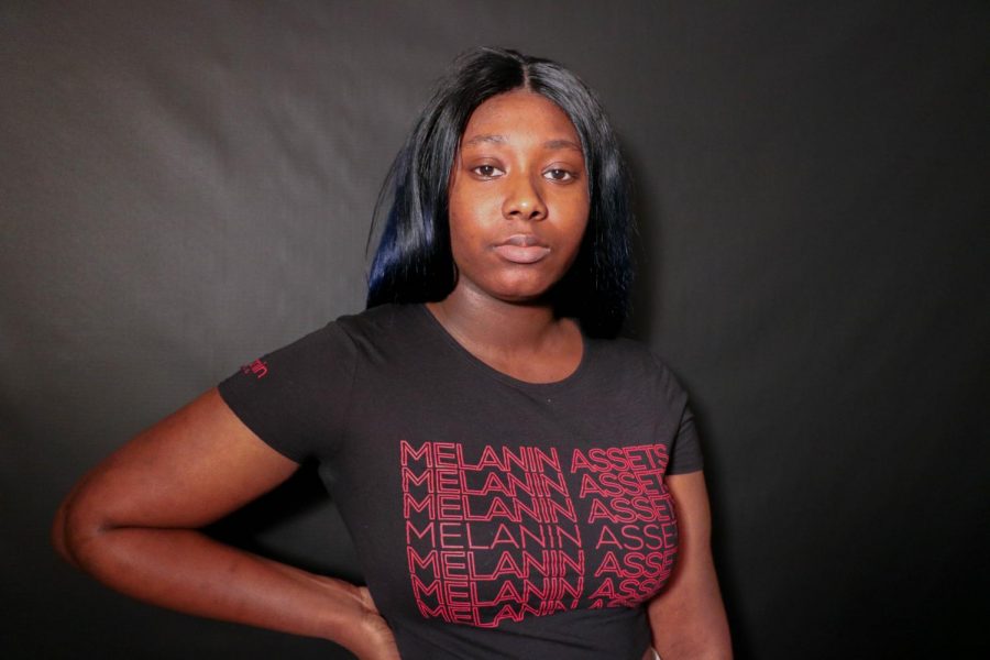 Senior Aissata Haidara poses in a shirt that says MELANIN ASSETS (Jan. 18). Racism happens all the time, it happens to me, it happens to everyone of a different race.
