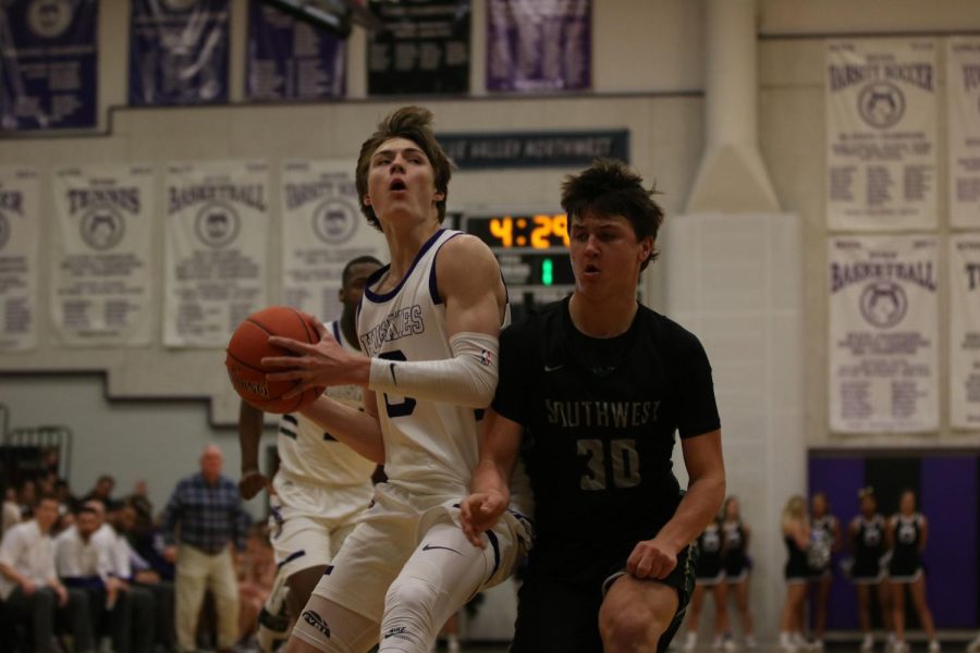 Senior guard Christian Braun pulls back for a shot during Sweetheart game against Blue Valley Southwest, Friday Feb. 1. BVNW defeated BVSW, 70-48. 