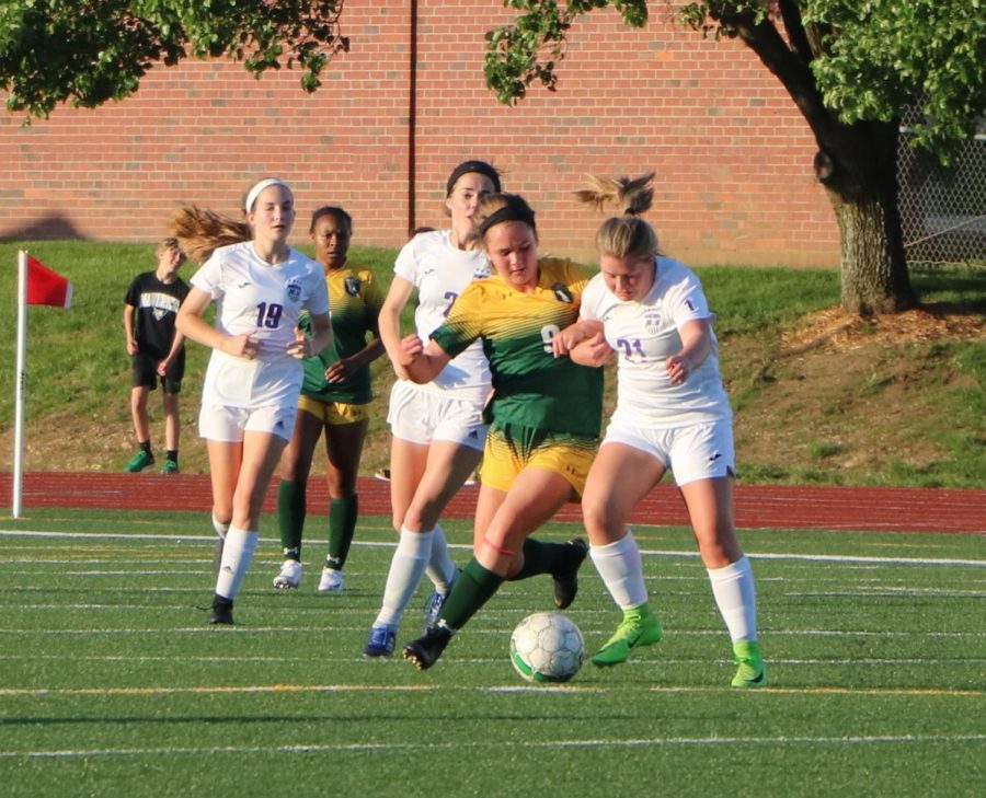 Senior Sydney Reeder battles for the ball with an opponent in the regional championship game against Shawnee Mission South on May 16. BVNW was defeated by SMS, 1-3. 