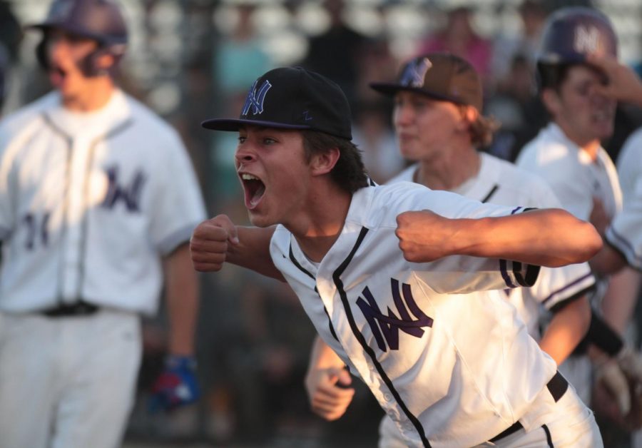 Junior Jackson Mehlin celebrates a win over Blue Valley, Tuesday May 14. The Huskies defeated the Tigers, 7-6.