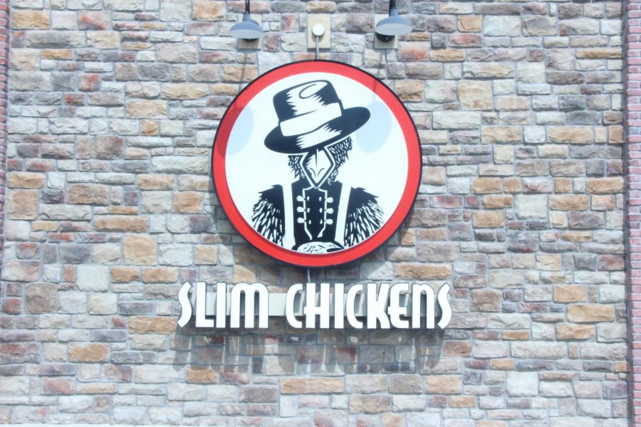 The+red+and+white+Slim+Chickens+logo+is+hung+outside+of+the+restaurant.+
