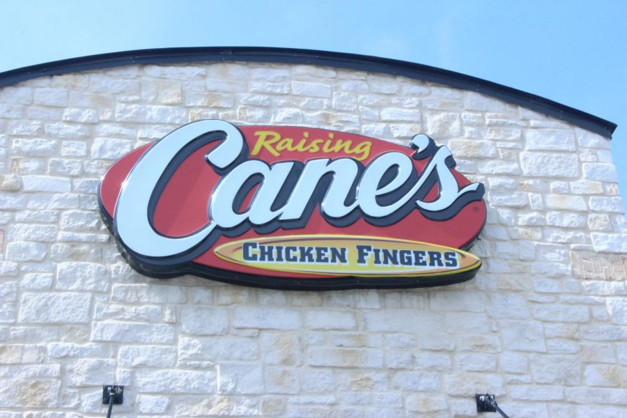 The+Raising+Canes%2C+outlined+in+red+and+yellow%2C+is+shown+in+front+of+the+restaurant.+