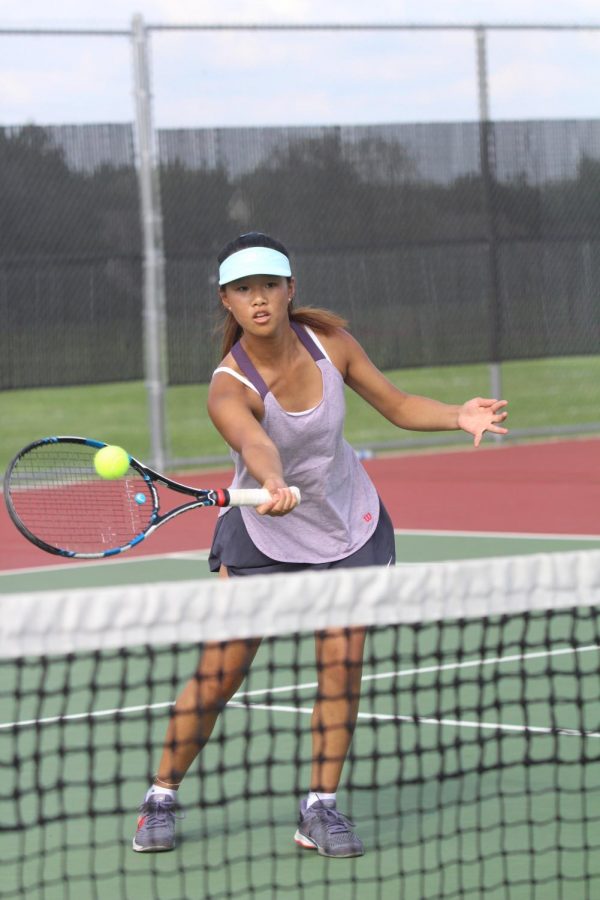Junior Grace Yan hits a ball against Shawnee Mission East on Sep. 13.