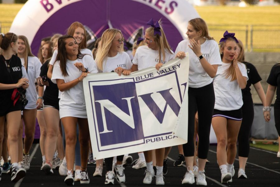 BVNW Yearbook staff walks through the tunnel and across the track during the Husky Night parade, on Aug. 30. 