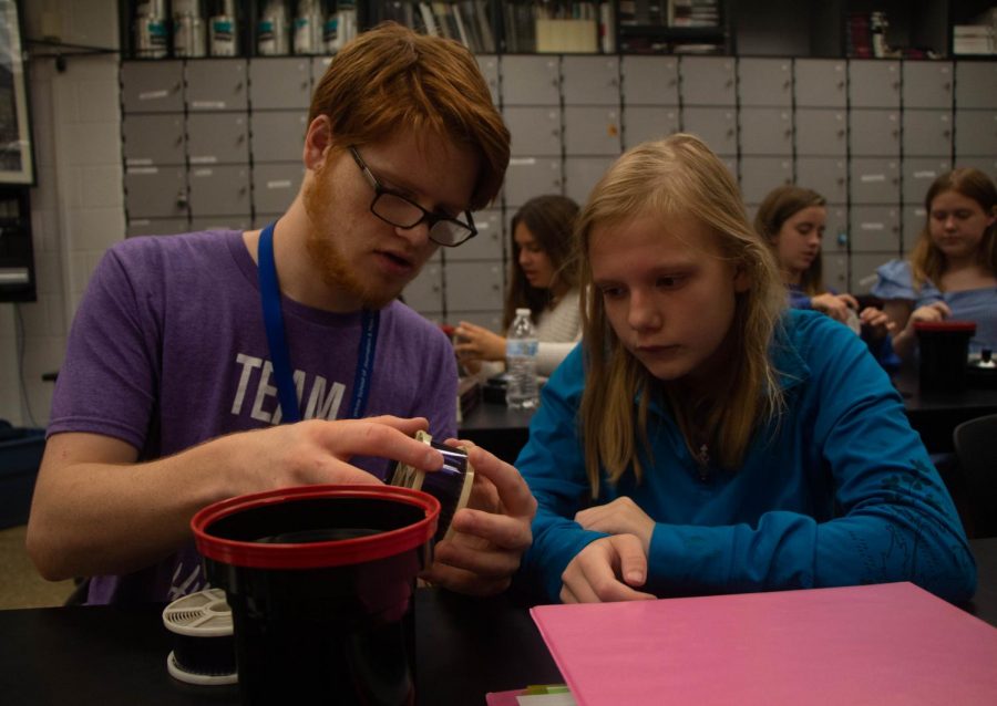 Matthew Maher helps sophomore Ashleigh Eblen develop film in art teacher Melanie Mikel’s photography class. “The students are
always so happy to be there. They don’t judge anyone and they always come in with a smile on their face,” Maher said.