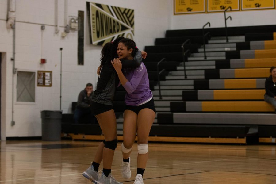 Senior Meiko Pearson hugs sister Alayna Pearson after losing final game of season to Blue Valley, 2-0.