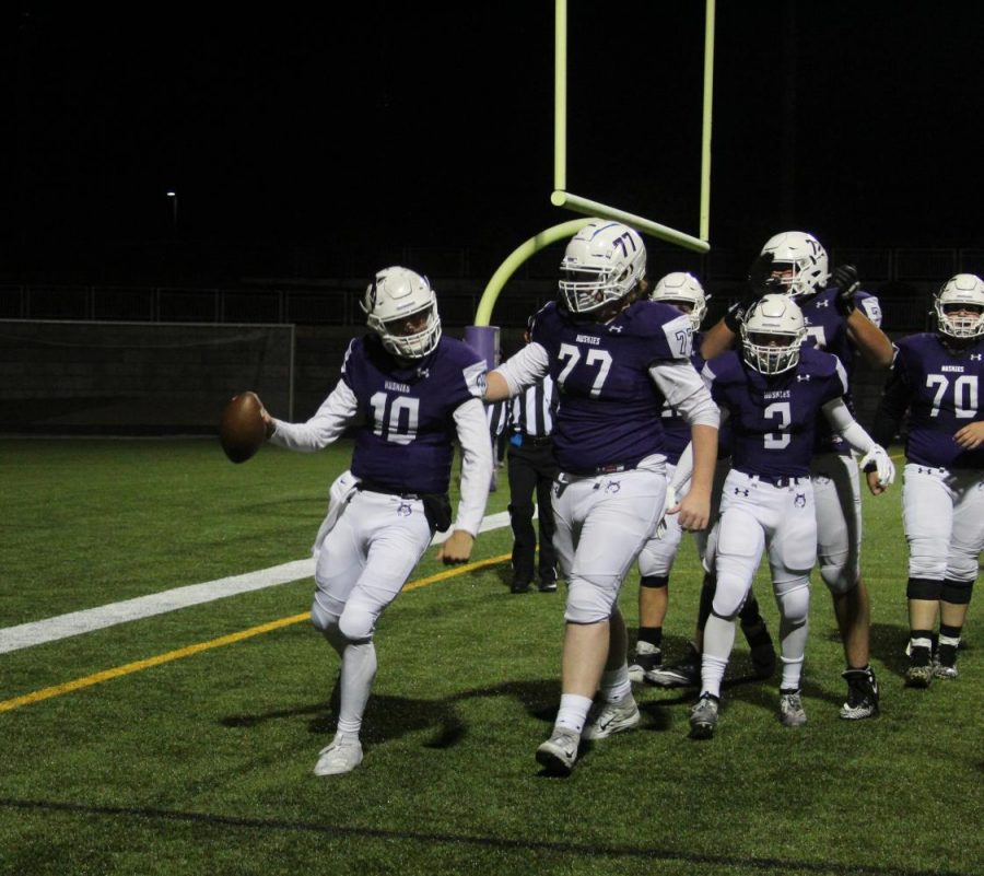 Sophomore quarterback Mikey Pauley celebrates a touchdown during the varsity football game, on Oct. 11.