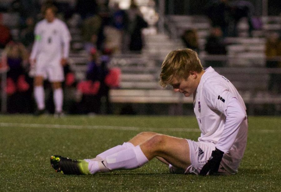 Senior Sam Stecher sits on the field after the game against Shawnee Mission East, on Oct. 31. 