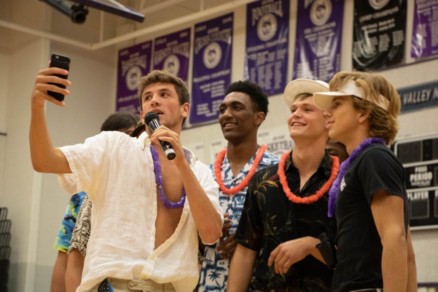 Seniors John Fischbach, Phil Miller, Ryan Callahan and Jake Dolesh talk into a microphone during the senior dance on Oct. 7. 
