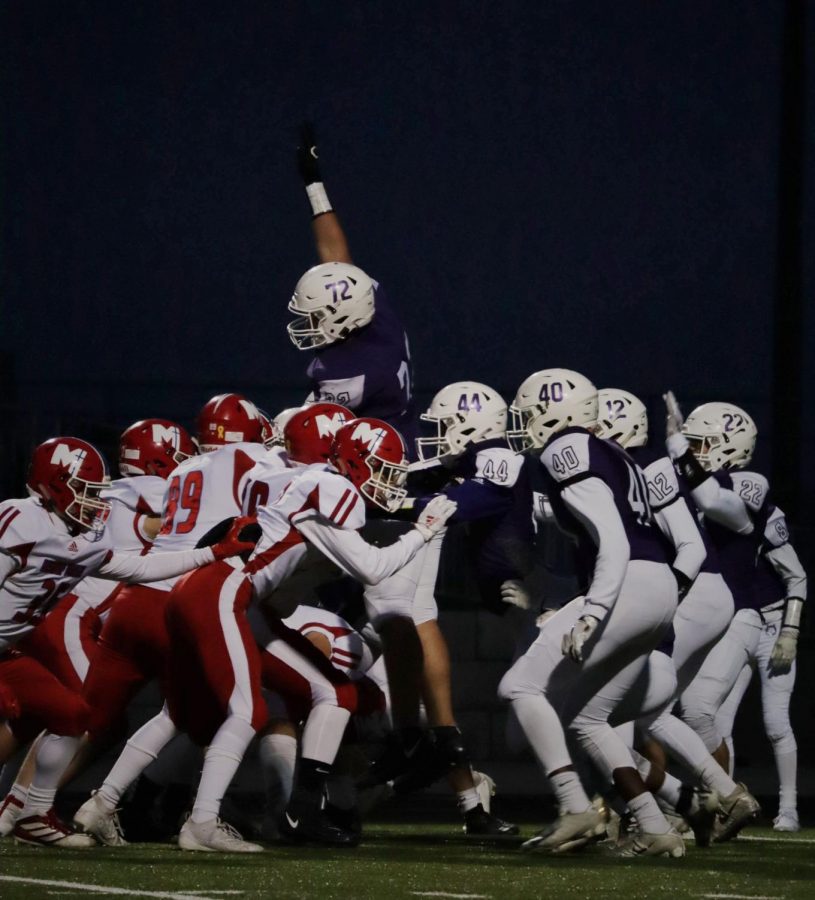 Senior Danny Robinson jumps with his hand in the air during the varsity football game against Bishop Miege, on Oct. 24. 
