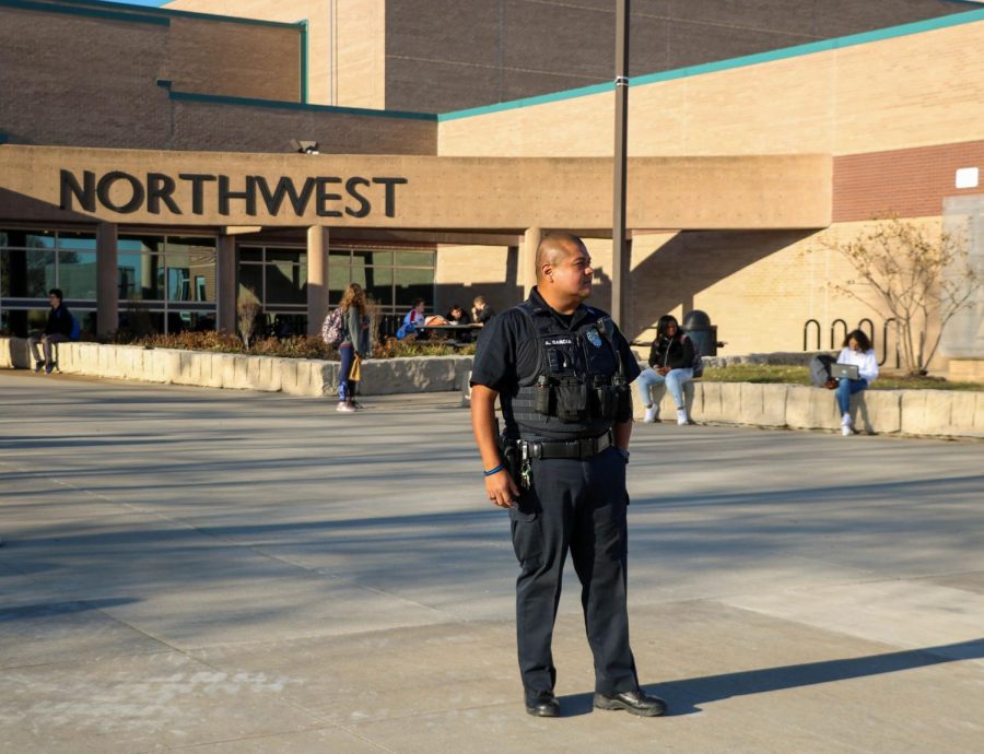 BVNW SRO Anthony Garcia stands outside the main entrance for dismissal Monday. There was an increased police protection at BVNW in reaction to a threat against the school. 