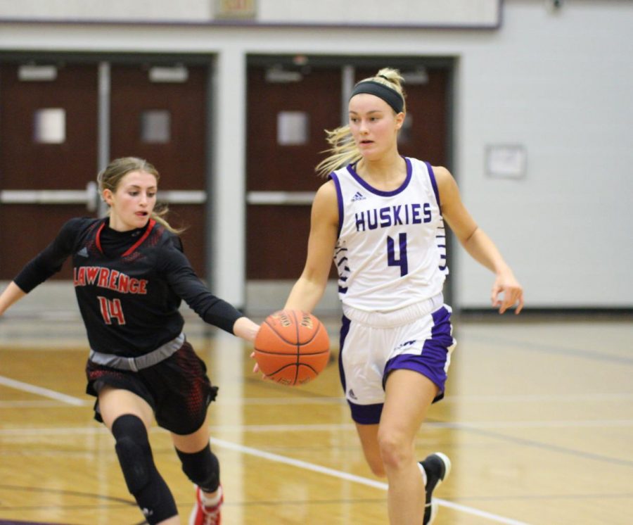Senior Grace Coble avoids a turnover while dribbling the ball down the court.