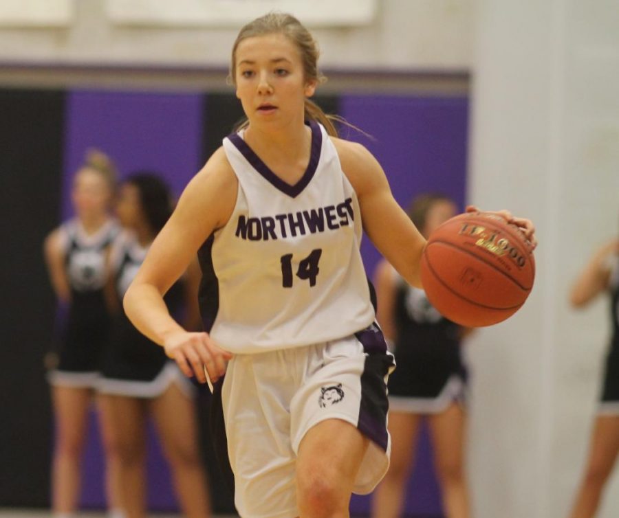 Junior+Megan+Edwards+dribbles+the+ball+up+the+court+in+the+varsity+basketball+sweetheart+game.