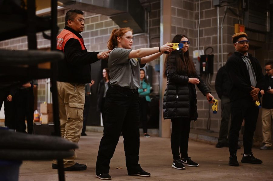 Senior Taylor Crowell aims a stun gun at a dummy. “My favorite part of Explorers is getting to meet all these new people from
different schools, and getting to know the officers who volunteer their time. We have so much fun and it’s nice to see more into
the daily life of a police officer, and you just get a whole new perspective and newfound appreciation. So meeting new people and
gaining these connections is my favorite part,” Crowell said. 