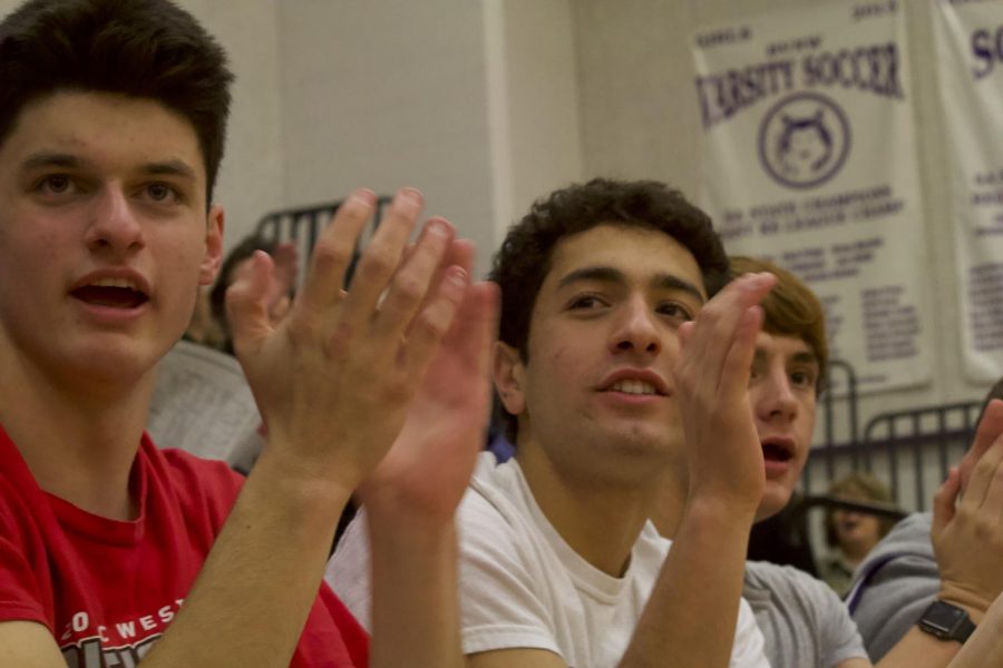 Sophomores Brain Nicholson, Yousif Radhi and Aidan Barnes cheer together at a home JV basketball game.