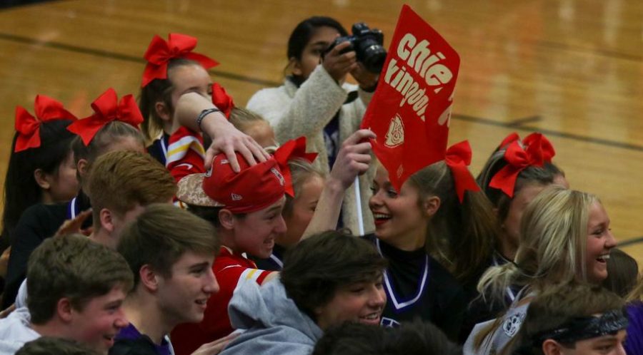 Junior Jeremy Bredemeier waves a Chiefs Kingdom flag during the Sweetheart assembly, Jan. 31. Bredemeier is a life-long Chiefs fan.