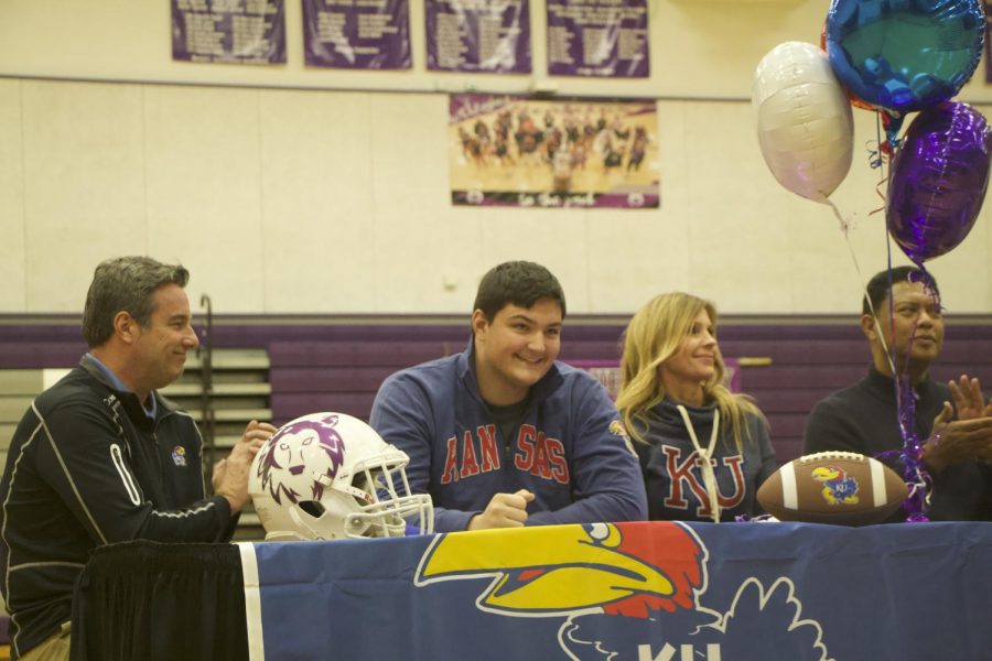 Senior+Danny+Robinson+signs+with+the+University+of+Kansas+to+play+football+during+the+spring+athletic+signing+ceremony%2C+Feb.+6.+