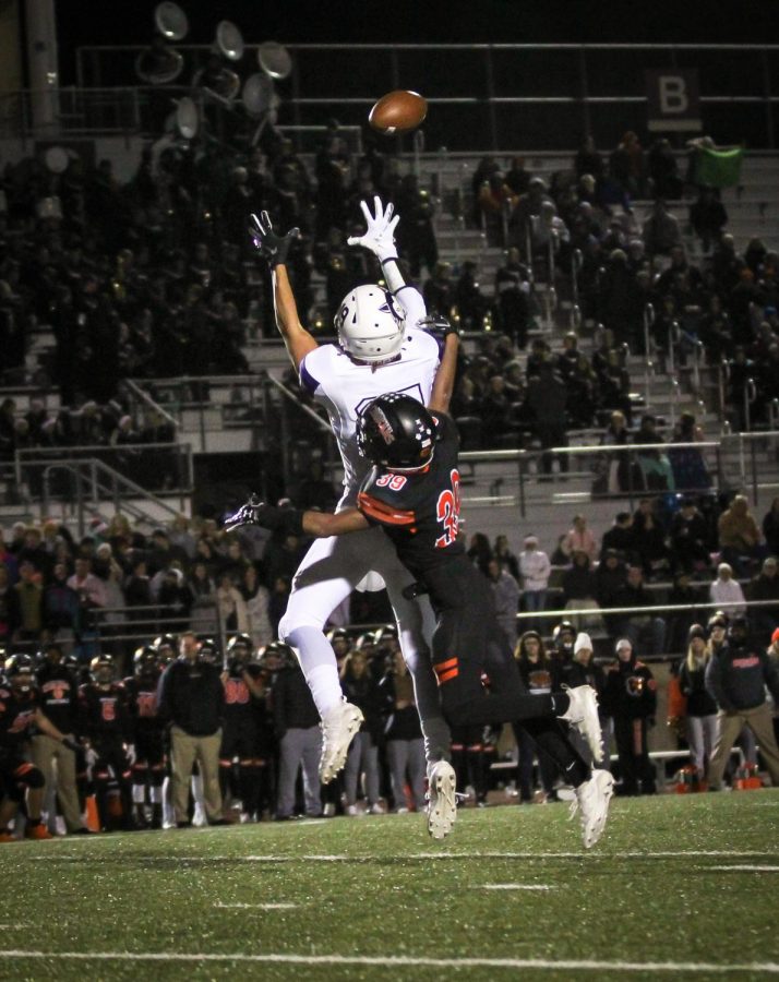 Senior Evan Ranallo jumps to catch a pass during the varsity football game against Shawnee Mission Northwest, Nov. 1.