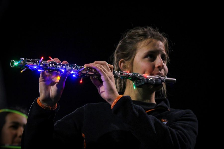 Junior Amy Winkler plays the flute during the Howlin Husky marching bands annual Glow Show, Nov. 2.