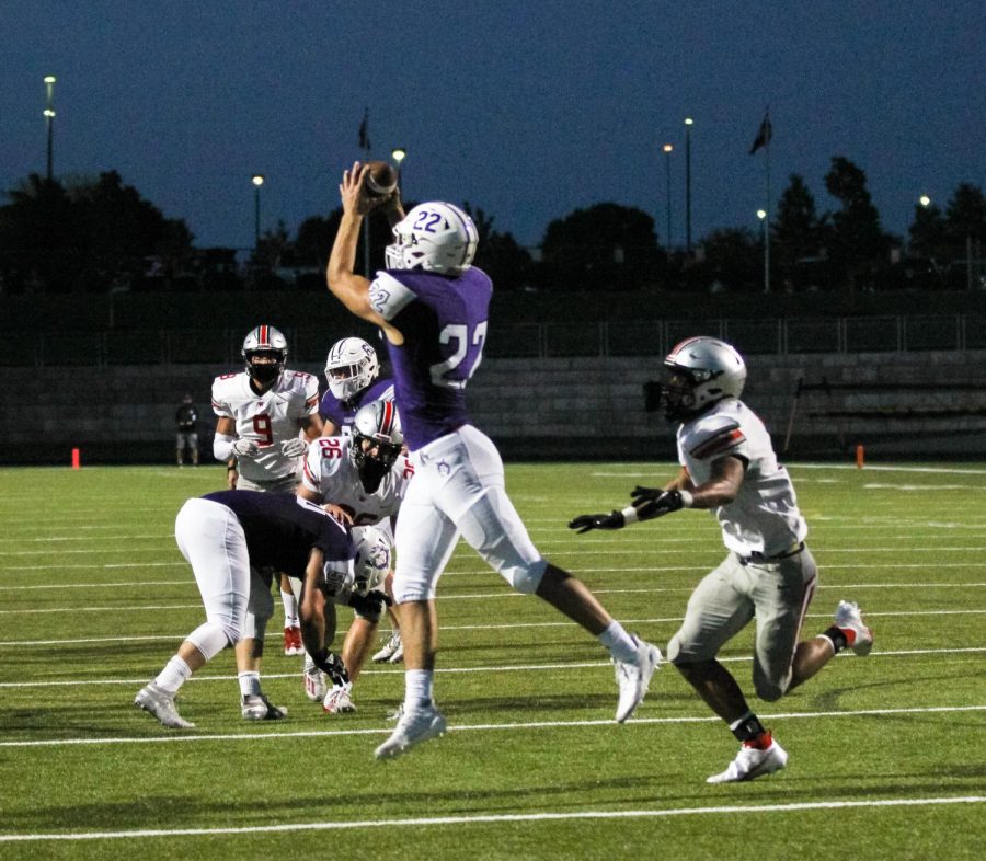 Junior Drew Kaufman jumps to successfully catch a pass during the varsity football game against BVW.