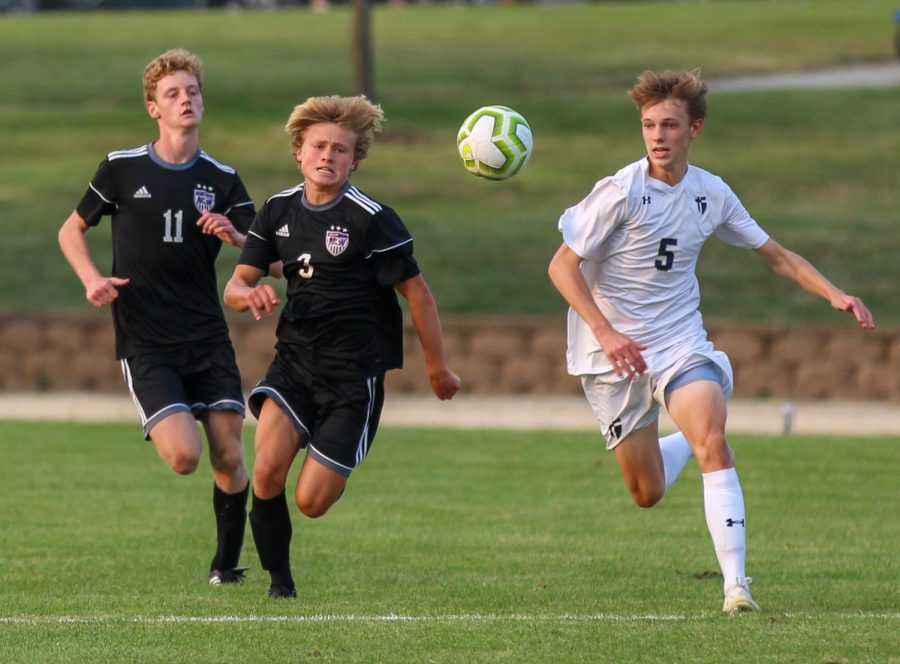 Sophomore Sam McIntosh (3) and senior Ethan Hunt (11) chase the ball in the boys varsity soccer game, Sept. 17.