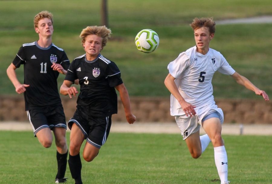 Sophomore Sam McIntosh (3) and senior Ethan Hunt (11) chase the ball in the boys varsity soccer game, Sept. 17.