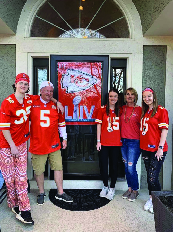 Jeremy, Paul, Laura, Lisa, and Lily Bredemeier pose outside their house after they had finished putting up decorations for their Super Bowl party. Feb. 2. 