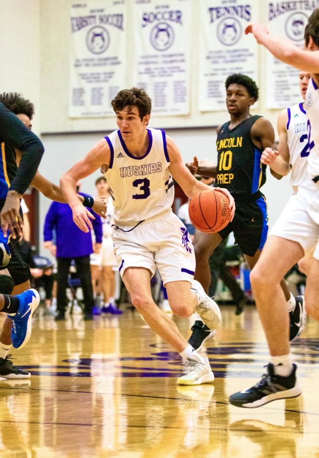 Senior Jack Chapman (3) drives into the paint against Lincoln Prep Academy.