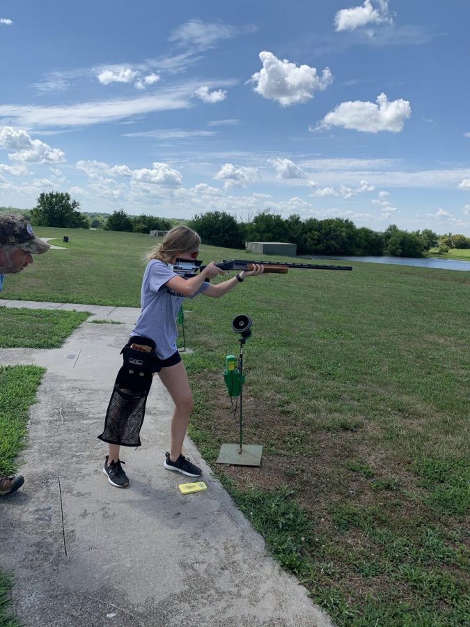 Junior Lexi Liess practices trap shooting with her father, Rich Liess. 