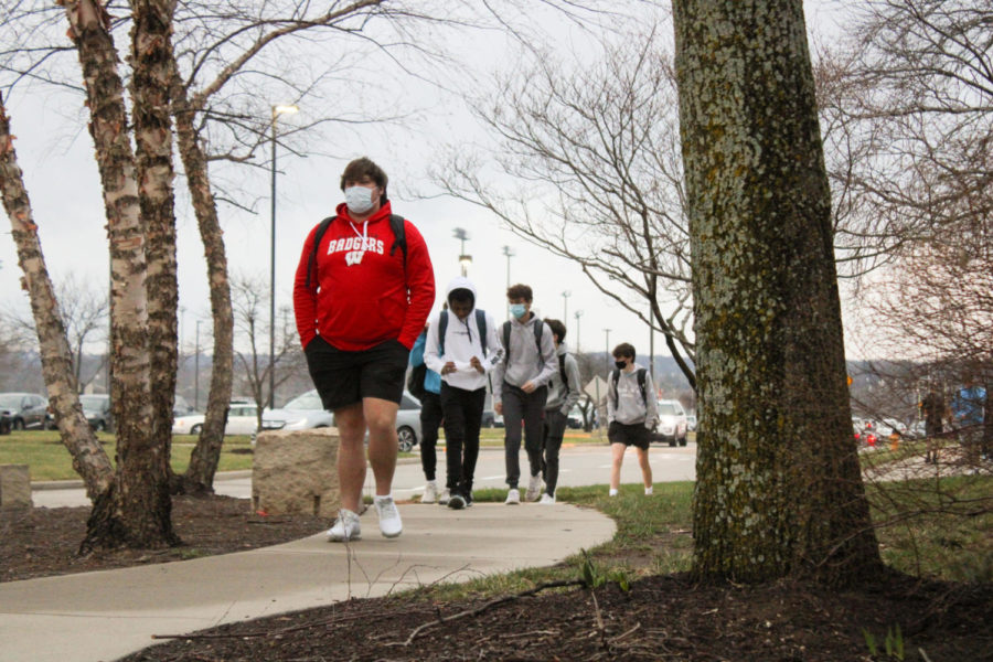 Students walk into the building for their first day of the fourth quarter, where all students will return to all in-person classes, March 23. 