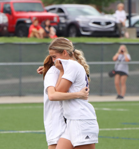 Junior Megan Yates (left) consoles senior Isabel Schelhammer (right) after the Huskies loss in the state quarterfinals.