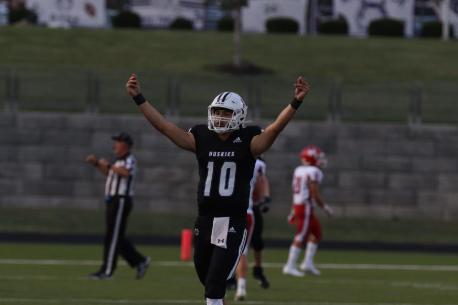 Senior quarterback Mikey Pauley celebrates scoring a touchdown during the football game against Bishop Miege High School, Sept. 10. 