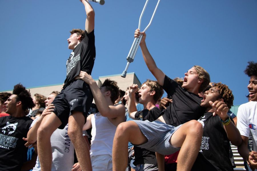 Juniors Jack Kreisman and Connor White being held up by their peers as they cheer at the Husky Pep Rally, Aug. 27.