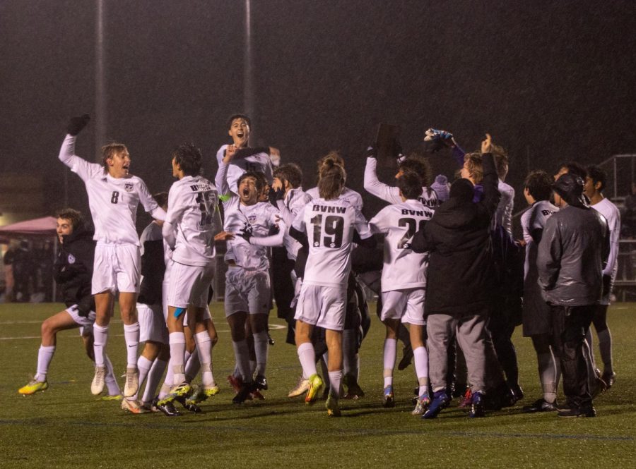 The varsity soccer team celebrates after winning the regional championship over Shawnee Mission East, 2-1, Oct. 28.