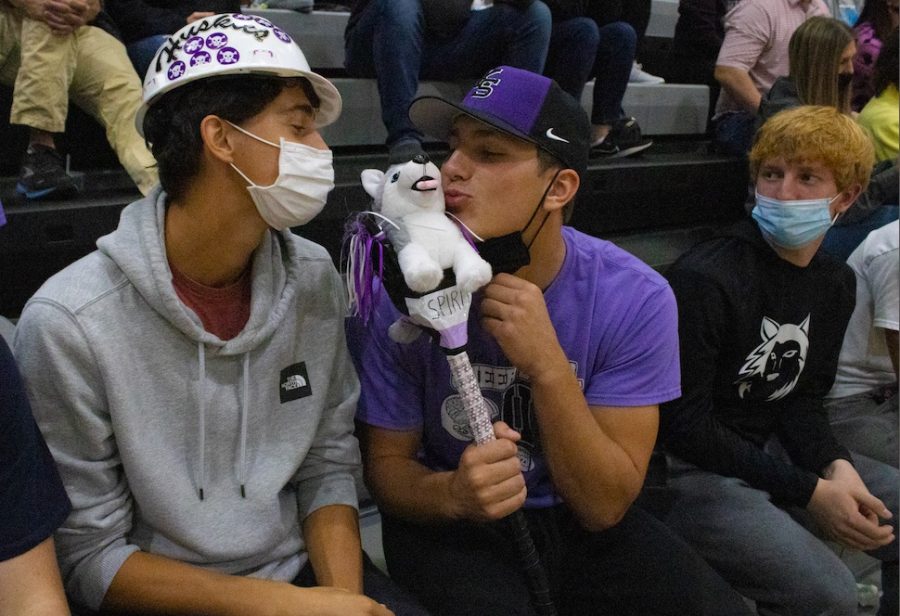 Kissing the spirit stick, seniors Joseph Rahto and Drew Kaufman cheer on the volleyball team at their substate game, Oct. 23.