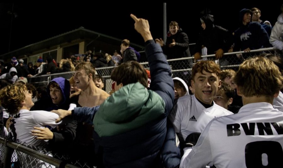 The boys soccer team celebrates with the student section after winning the state quarterfinal game, 4-3, Nov. 2.