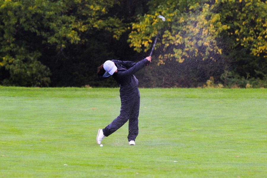 unior Reagan Kauth takes a practice swing, Sept. 11. Kauth represented the Huskies in the state golf tournament.