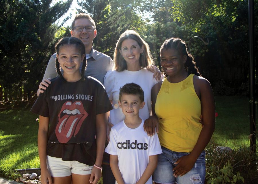 Sophomore Harper Latta poses with her parents and siblings Waverly and Everett Latta, Oct. 11. “I’ve known them my whole life, so yeah they’re my parents there’s nothing different about it,” Latta said.