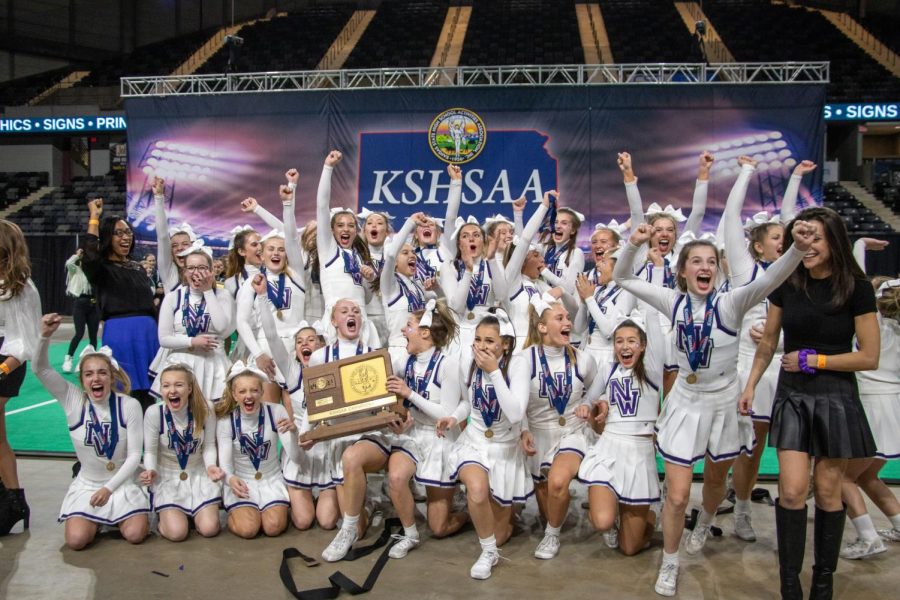 The varsity cheerleading squad celebrates after winning the 6A state championship, Nov. 20.