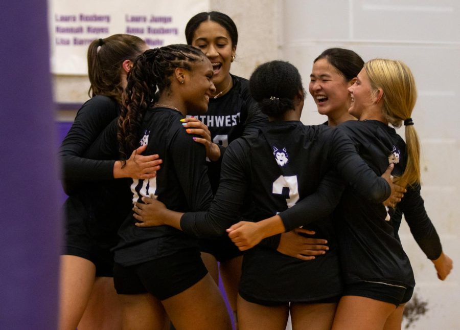 The girls varsity volleyball team celebrates after scoring a point during a scrimmage that took place on Husky Night, Aug. 22.