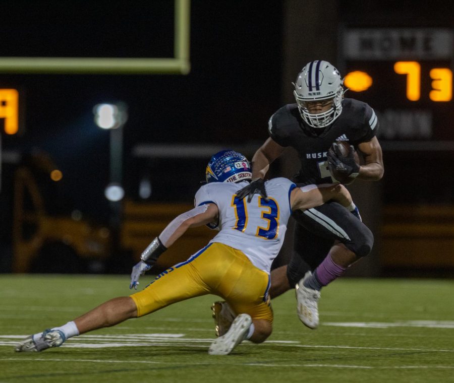 Senior Grant Stubblefield runs the ball in a varsity football regional game against Olathe South, Nov. 5.(Photo by Lindsey Farthing)