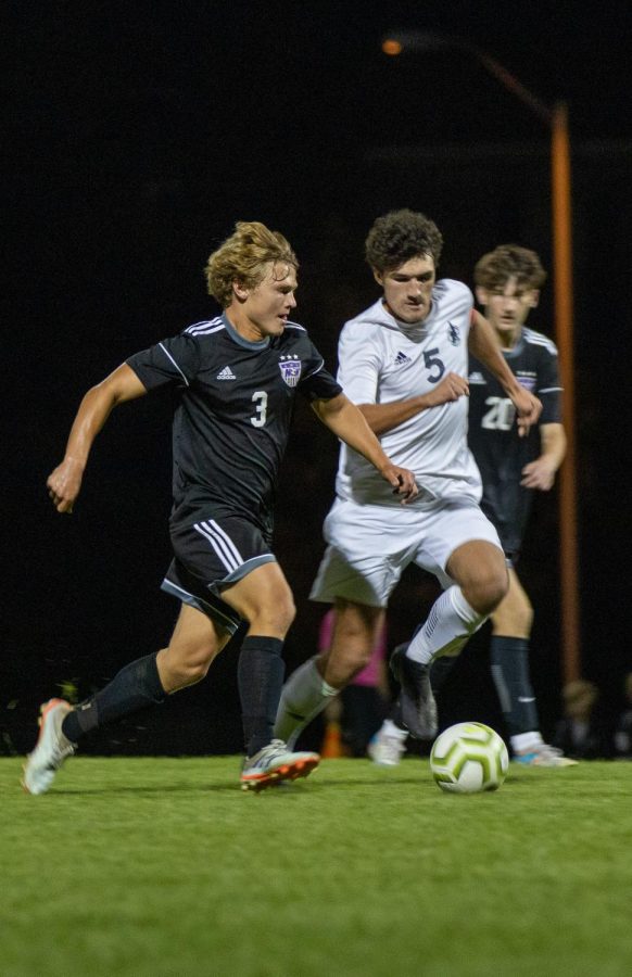 Senior Sam McIntosh dribbles the ball in a game against Blue Valley Southwest. (Photo by Lila Vancrum)