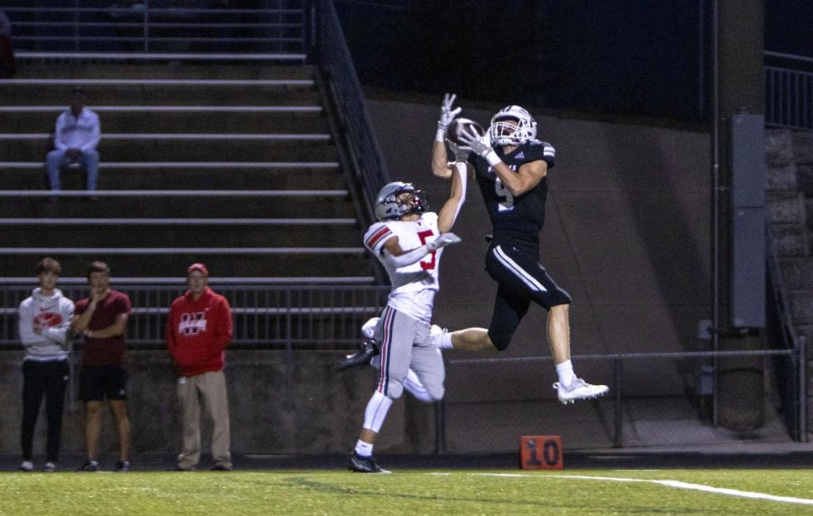 Junior Gavin Hoffman catches the ball for the Huskies fourth touchdown of the night, making the score 26-14, Sept 30.