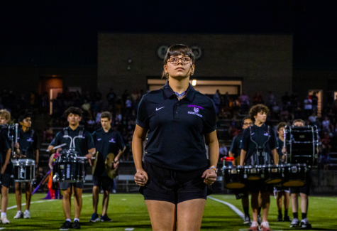 Senior Regan Cavin leads the band at halftime during the football game, Sep. 9.